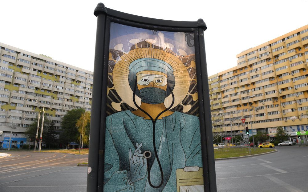 Romania: Orthodox Church blasts posters of doctors as saints, Catholics supportive