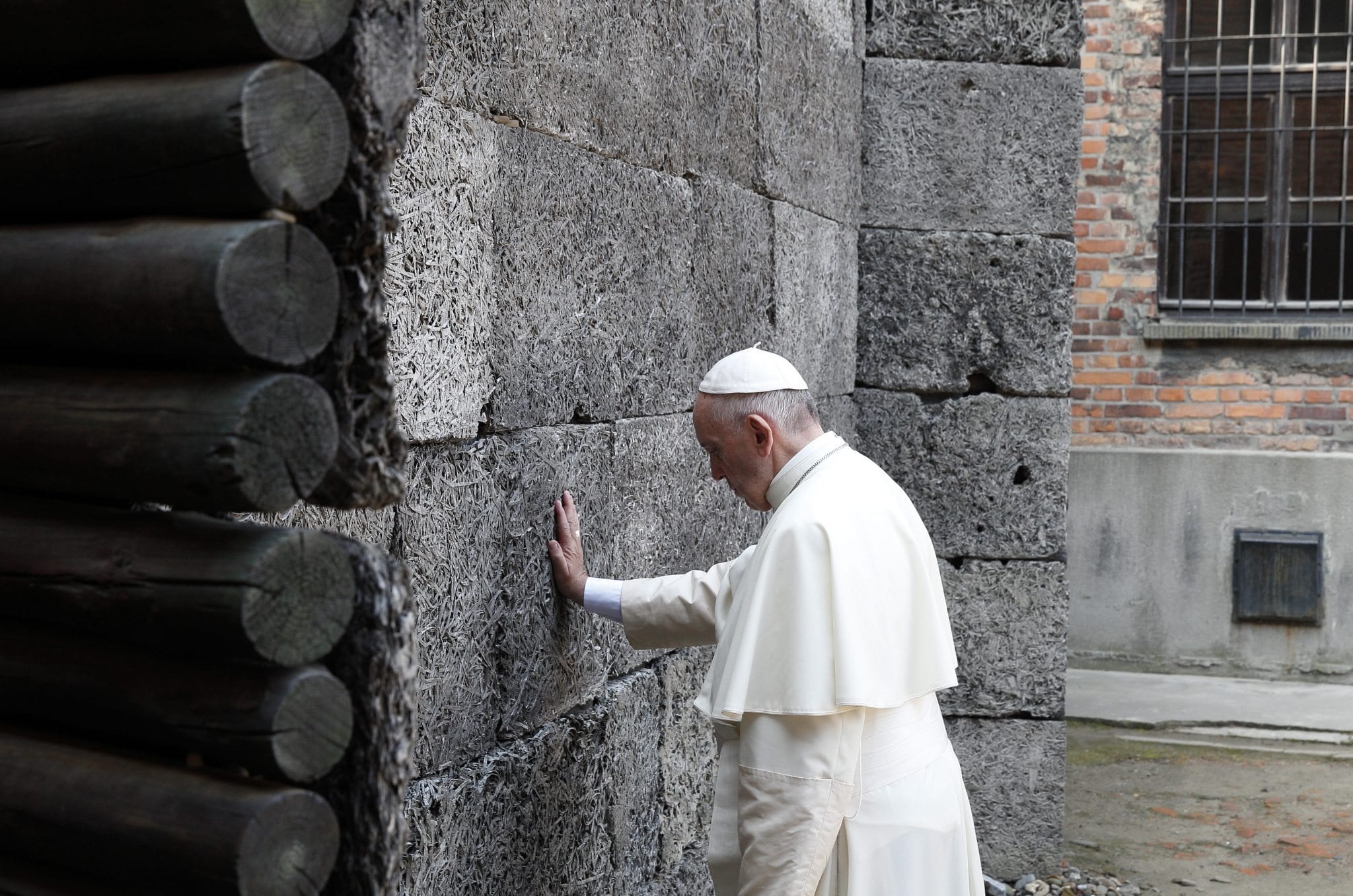 Francis says the violence of Auschwitz is ongoing