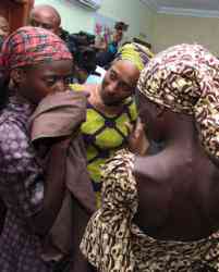 Oludolapo Osinbajo, wife of Nigerian Vice President Yemi Osinbajo, consoles one of the 21 released Chibok girls Oct. 13 in Abuja. (Credit: CNS photo/EPA.)