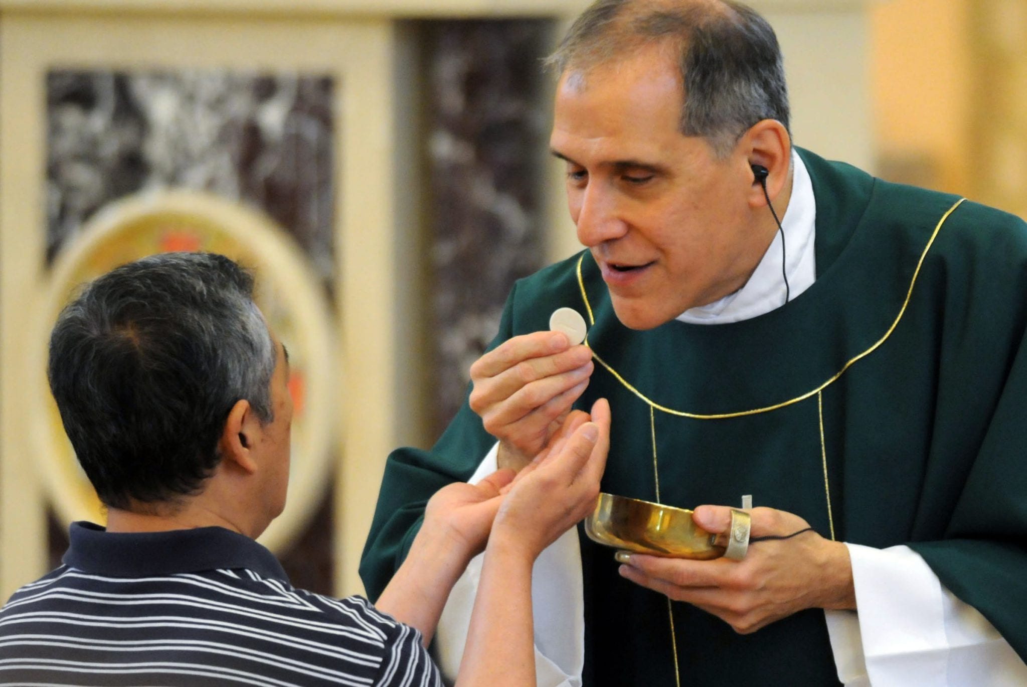 Being legally blind doesn’t hinder Catholic priest in serving his flock