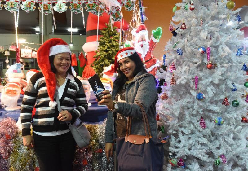 Far from home, Israel’s foreign workers visit pop-up Christmas market