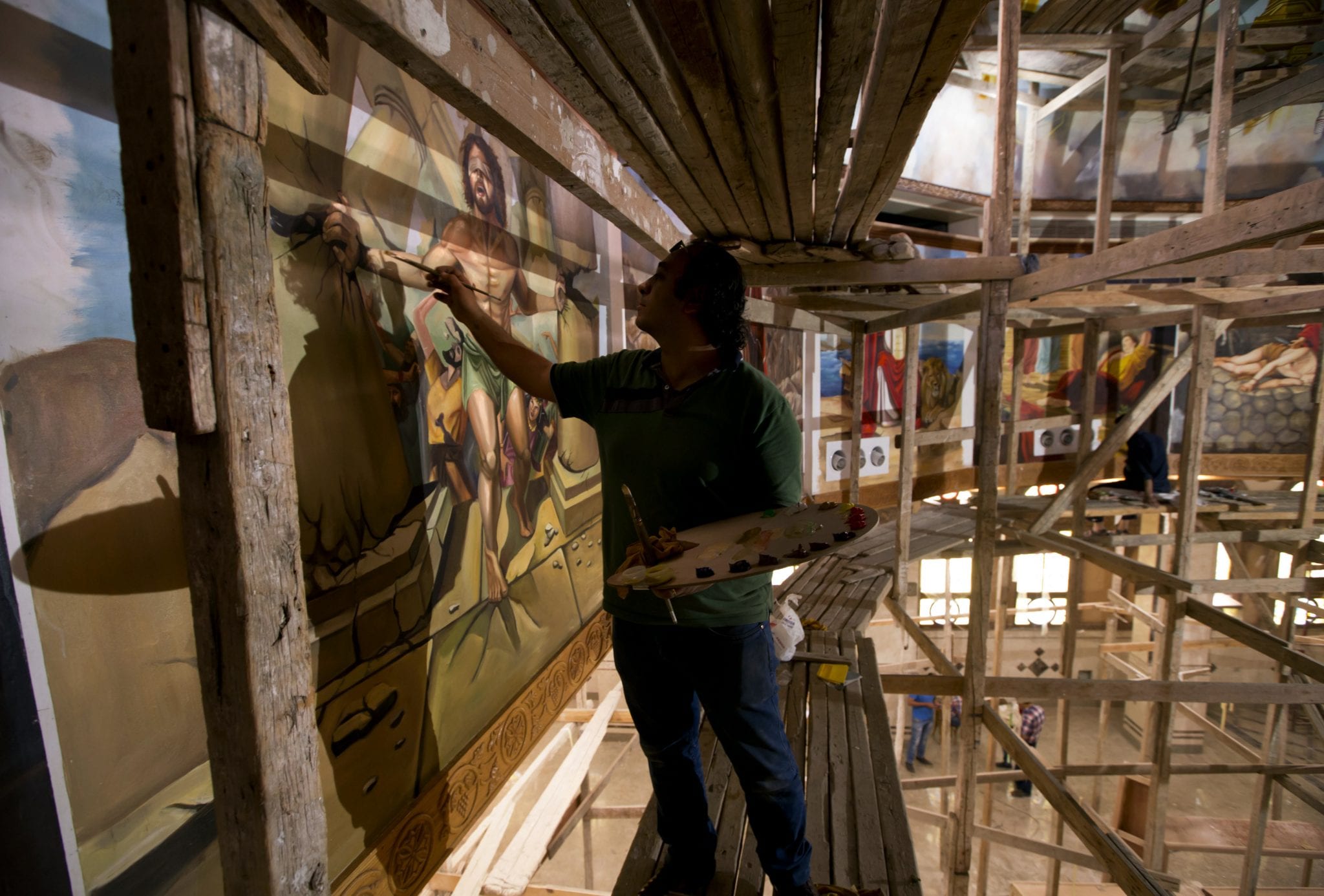 Egyptian artist paints church murals, unfazed by attacks