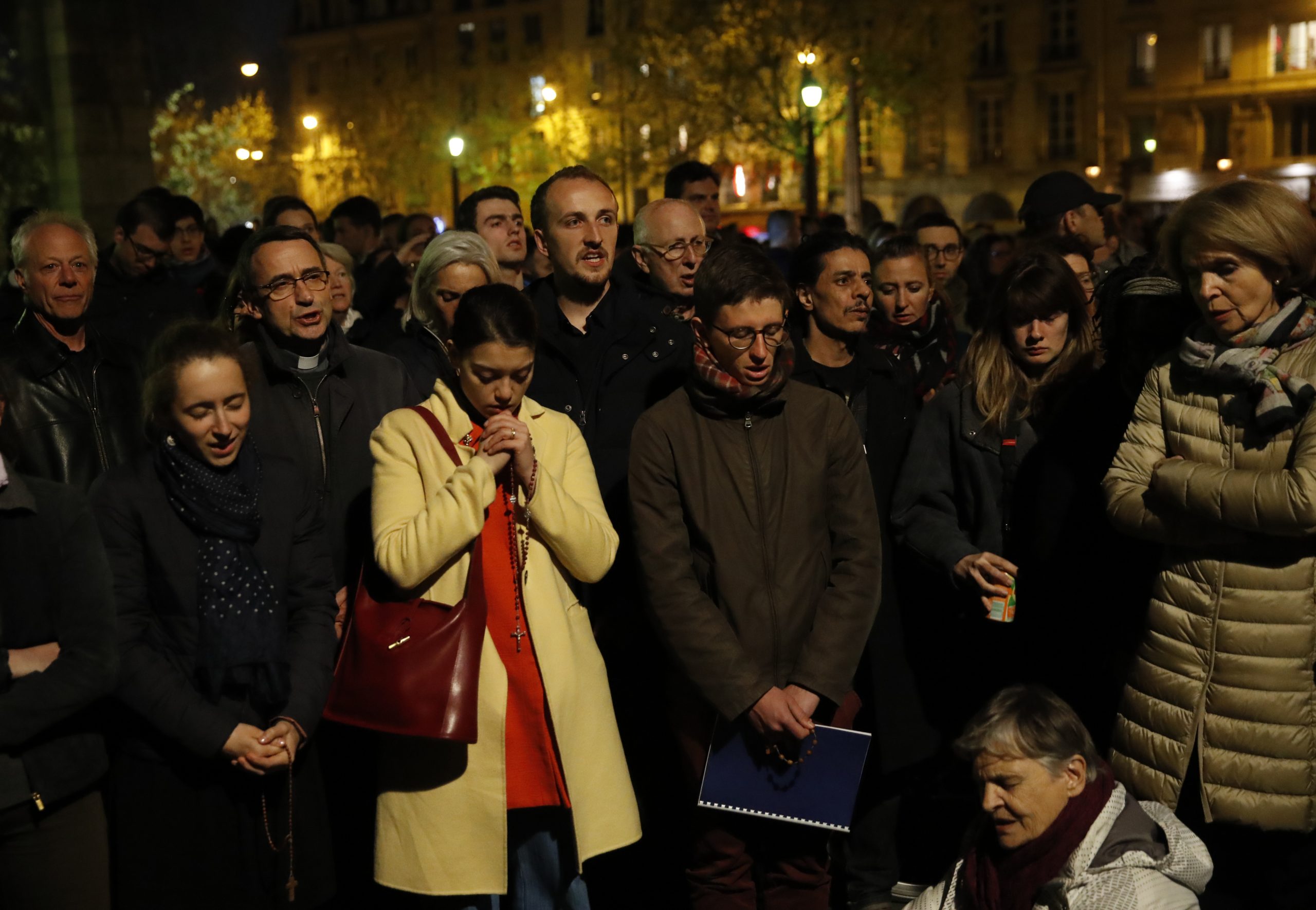 Prayers, hymns, community shared in firelight of Notre Dame