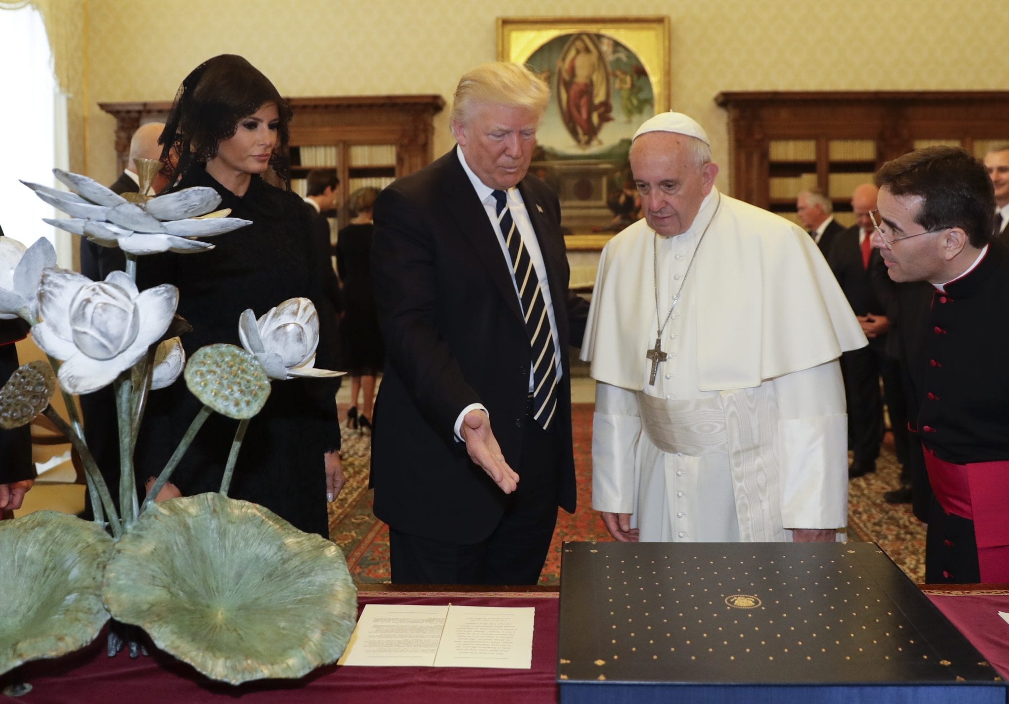 Pope Francis exchanges gifts with President Donald Trump and his wife Melania on the occasion of their private audience, at the Vatican, Wednesday, May 24, 2017. (Alessandra Tarantino, AP Pool.)