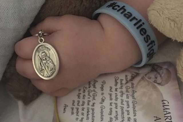 Charlie Gard was baptized, held St. Jude medal before death