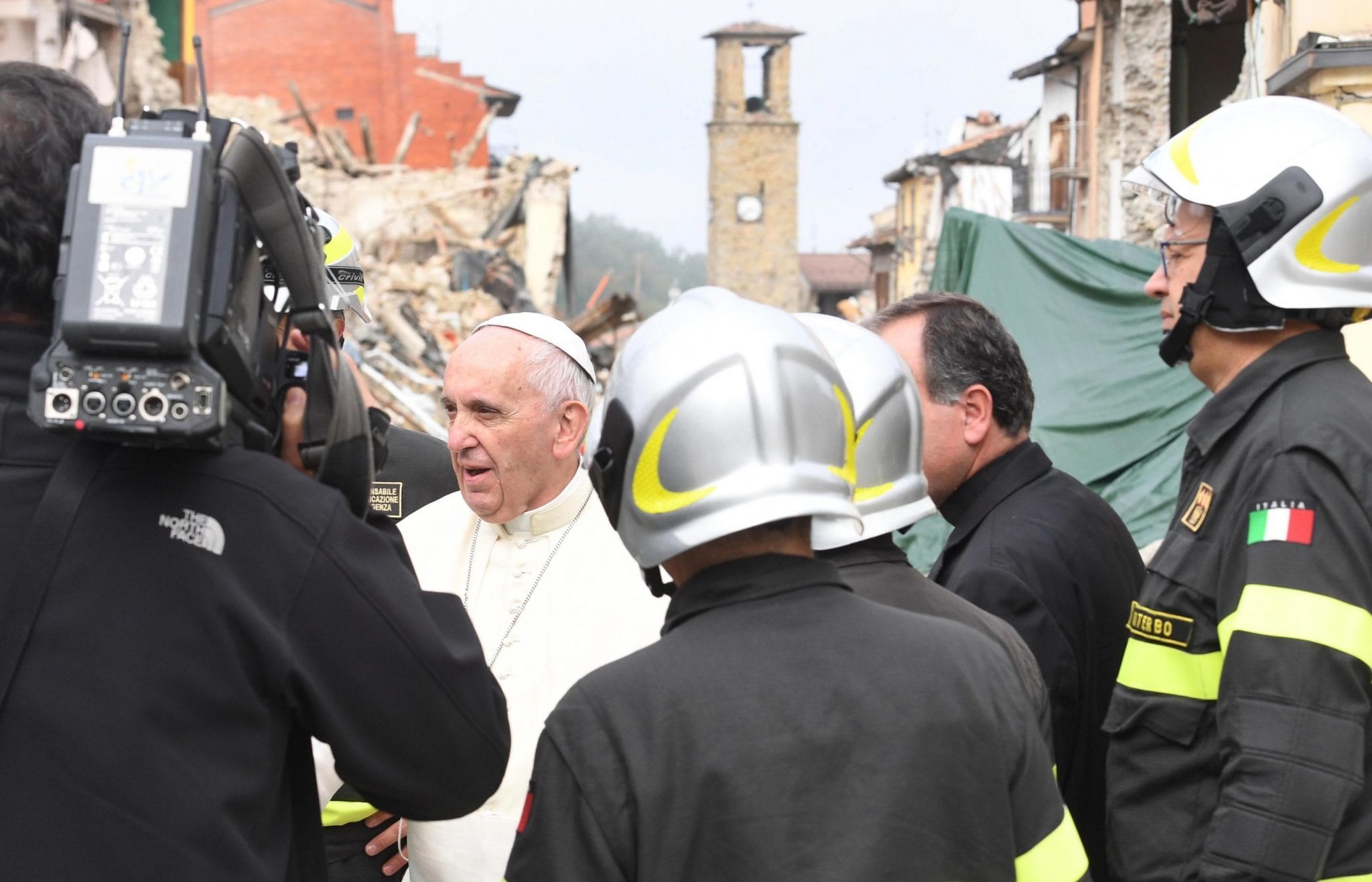 Pope Francis talks with firefighters in the quake-struck town of Amatrice, Italy, Tuesday, Oct. 4, 2016. (Credit: Alessandro Di Meo/ANSA via AP)