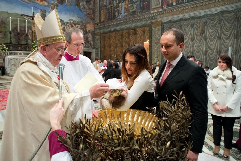 Pope baptizes newborns, helps homeless fight the cold