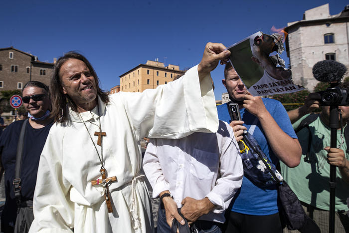 COVID deniers invoke Pope Benedict, burn image of Francis at Rome rally