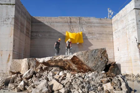 Workers use a jackhammer to break a block of travertine at the Degemar Quarry near Tivoli, Italy, 35 kilometers east of Rome, on Friday, Feb. 13, 2026, where 17th-century Baroque architect Gian Lorenzo Bernini selected travertine for the colonnade of St. Peter's Square. (Credit: Gregorio Borgia/AP.)