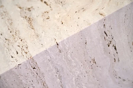 Light reverberates on a travertine block at the Mariotti Carlo SpA stonecutting firm in Tivoli, Italy, on Friday, Feb. 13, 2026; the block will be used to adorn the tower of the new Manhattan temple in New York City. (Credit: Gregorio Borgia/AP.)