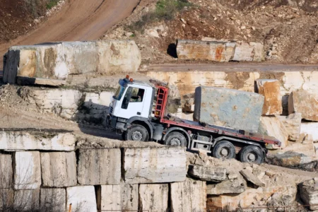 A truck carries a block of travertine at the Degemar Quarry near Tivoli, Italy, 35 kilometers east of Rome, on Friday, Feb. 13, 2026, where 17th-century Baroque architect Gian Lorenzo Bernini selected travertine for the colonnade of St. Peter's Square. (Credit: Gregorio Borgia/AP.)