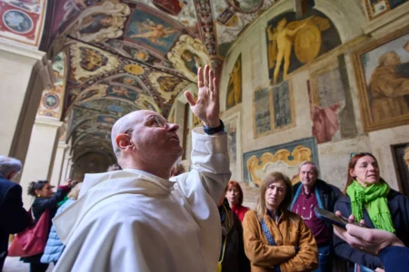 Friar Daniele Aucone, foreground, deputy director of the Basilica of Santa Maria sopra Minerva, guides journalists through the basilica’s cloister in Rome, Wednesday, March 18, 2026. (Credit: Domenico Stinellis/AP.)