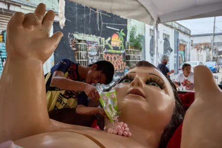 A parishioner offers candy to a giant Baby Jesus in Mexico City, Tuesday, March 10, 2026. (Credit: Ginnette Riquelme/AP.)