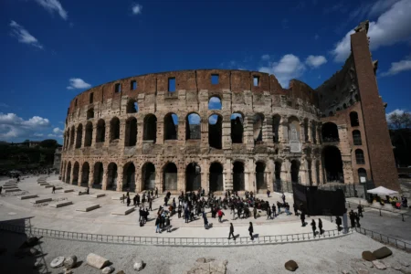 People walk in the new outdoor space created with travertine marble around the Colosseum during it’s inauguration in Rome, Tuesday, March 17, 2026. (Credit: Andrew Medichini/AP.)