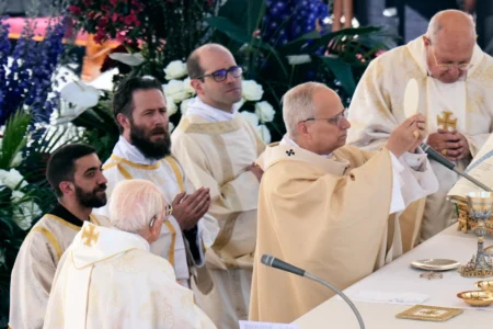 Pope Leo XIV, with Cardinal Kevin Joseph Farrell, chamberlain of the Holy Roman Church, right, and Cardinal Giovanni Battista Re, dean of the College of Cardinals, left, presides over Easter Mass in St. Peter’s Square at the Vatican, Sunday, April 5, 2026.. (Credit: Alessandra Tarantino/AP.)
