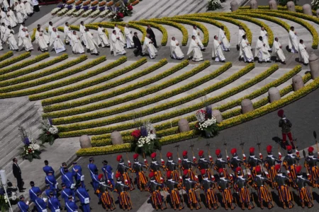 Priests reach toward the faithful to distribute Holy Communion as Pope Leo XIV presides over Easter Mass in St. Peter’s Square at the Vatican, Sunday, April 5, 2026. (Credit: Alessandra Tarantino/AP.)