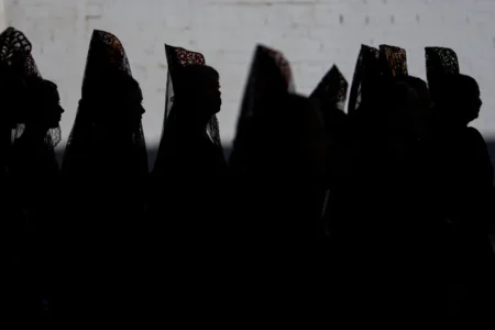 Women wearing traditional "mantillas" of the Franciscana de Pasion brotherhood take part during a Holy Week procession in Lucena, southern Spain, Monday, March 30, 2026. (Credit: Manu Fernandez/AP.)