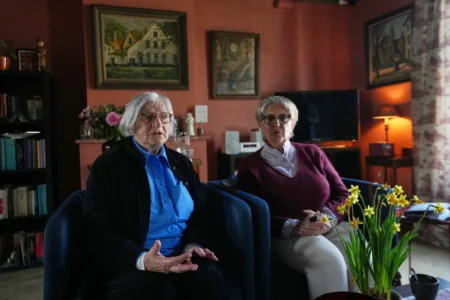 Brigitte Beernaert, left, and Jo Verplaetsen speak during an interview in a house inside the Beguinage Ten Wijngaerde in Bruges, Belgium, Wednesday, April 15, 2026. (Credit: Virginia Mayo/AP.)