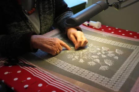 A woman demonstrates lacemaking in the Beguinage of Lier, Belgium, during an open day on Saturday, March 28, 2026. (Credit: Virginia Mayo/AP.)