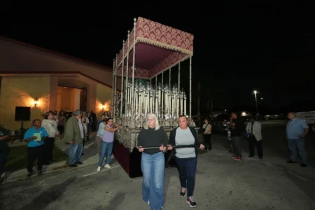 Corpus Christi Catholic Church members push a large float that will carry the Lady of Hope Macarena during a rehearsal for their Good Friday procession, Monday, March 23, 2026, in Miami, Fla. (Credit: Marta Lavandier/AP.)