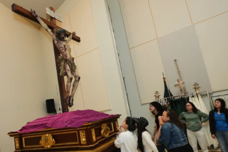 Corpus Christi Catholic Church youth members look up at a statue of Jesus crucified during a rehearsal for their Good Friday procession, Monday, March 23, 2026, in Miami, Fla. (Credit: Marta Lavandier/AP.)