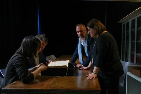 From left, Elisabetta Magnanti, Mark Faulkner of Dublin's Trinity College, Andrea Cappa and Valentina Longo of Rome's National Central Library examine a manuscript containing a rare, long-lost copy of Caedmon's Hymn — the first poem ever written down in Old English — at Rome's National Library, Thursday, May 8, 2026. (Credit: Andrea Rosa/AP.)