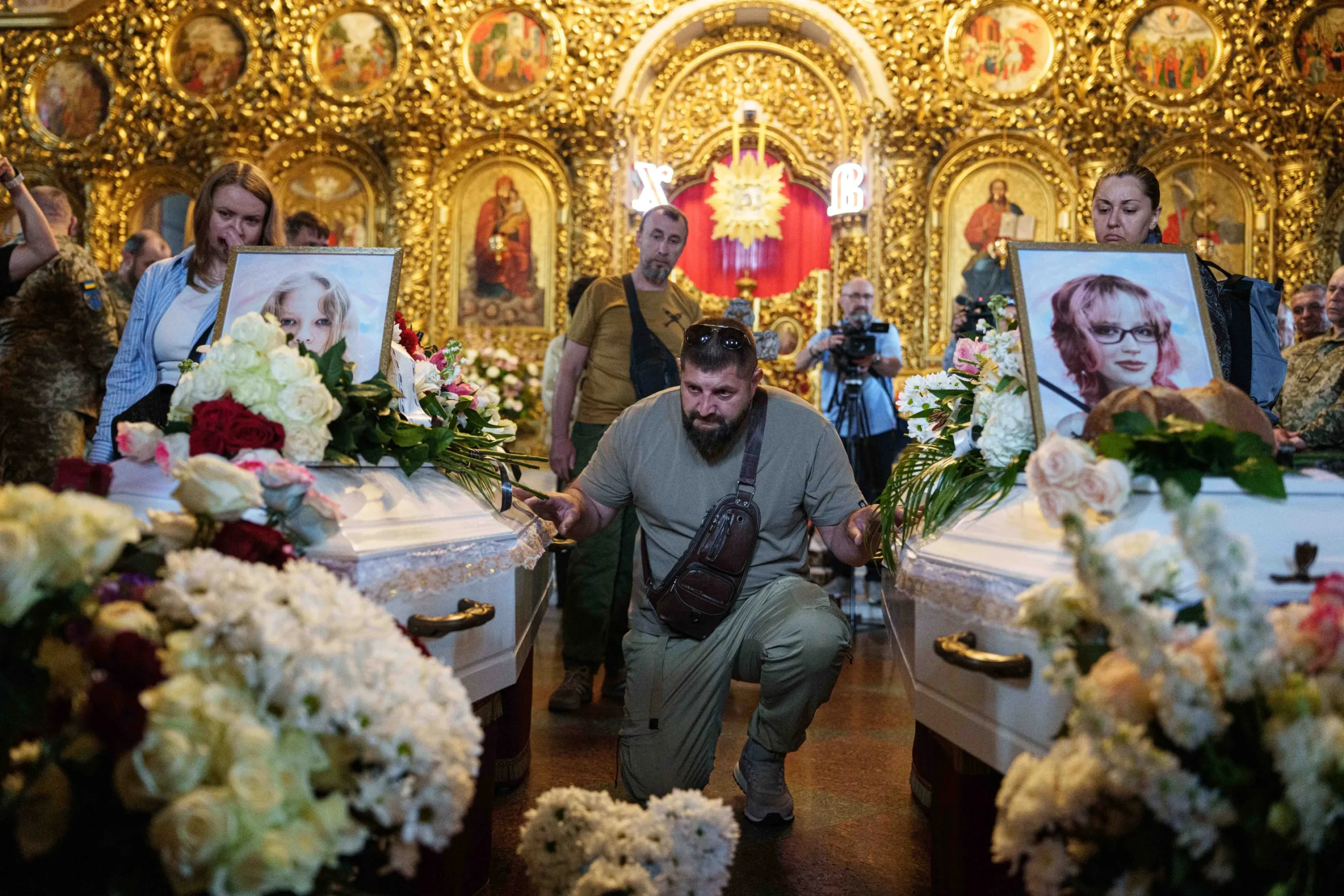 Kyiv holds a funeral for 2 young sisters killed by a Russian missile strike