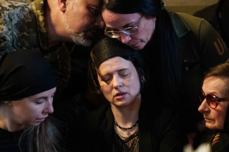 A mourns her daughters, sisters Liubava and Vira Yakovleva, killed by a Russian rocket strike during their funeral in Kyiv, Ukraine, on May 19, 2026. (Credit: Evygeniy Maloletka/AP.) 