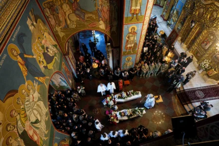 People attend the funeral of sisters Liubava and Vira Yakovleva, killed by a Russian rocket strike during their funeral in Kyiv, Ukraine, on May 19, 2026. (Credit: Evygeniy Maloletka/AP.) 