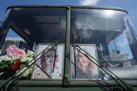 Portraits of sisters Liubava and Vira Yakovleva, killed by a Russian rocket strike during their funeral in Kyiv, Ukraine, on May 19, 2026. (Credit: Evygeniy Maloletka/AP.) 