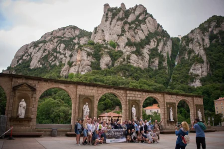 Tourists pose for a photo at the main square of the Monastery of Montserrat near Barcelona, Spain, Friday, June 5, 2026. (Credit: Emilio Morenatti/AP.)