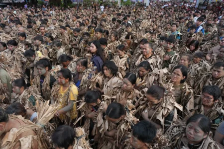 Catholics covered in mud and dried banana leaves participate at the mud people festival on the feast day of Saint John the Baptist at Bibiclat, Nueva Ecija province, northern Philippines on Wednesday, June 24, 2026. (Credit: Aaron Favila/AP.)