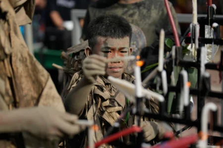 Catholic youth Marcus Miel Neuda covered in mud and dried banana leaves participate at the mud people festival on the feast day of Saint John the Baptist at Bibiclat, Nueva Ecija province, northern Philippines on Wednesday, June 24, 2026. (Credit: Aaron Favila/AP.)