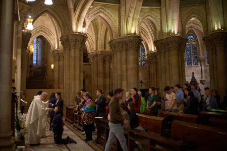 Worshippers receive communion during a Mass in the crypt of the Sagrada Familia in Barcelona, Spain, on Friday, May 15, 2026. (Credit: Emilio Morenatti/AP.)