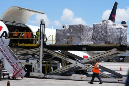 People load pallets containing food and hygiene kits for a humanitarian assistance flight to Cuba organized by the Trump administration as the U.S. continues to put pressure on the island's government, Tuesday, July 21, 2026, in Miami. (Credit: Lynne Sladky/AP.)