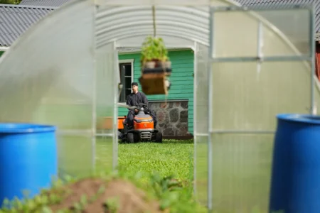 Father Paisios drives a riding lawn mower at the newly founded Kirikla Orthodox Monastery in Pihali village, Estonia, on July 4, 2026. (Credit: Sergei Grits/AP.)