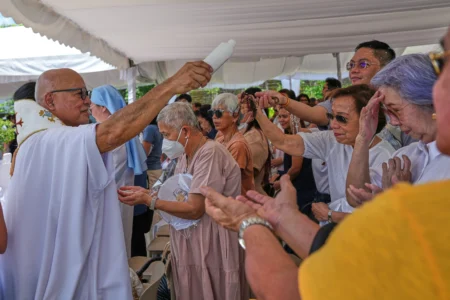 Catholic priest Father Dennis Paez sprinkles holy water to pilgrims during their visit at the Ephesus House, a replica of the House of the Virgin Mary in Ephesus, Turkey, at Alfonso town, Cavite province, Philippines on July 16, 2026. (Credit: Aaron Favila/AP.)