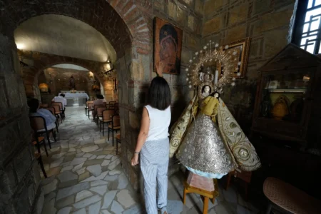 A Catholic woman touches a religious icon during her visit at the Ephesus House, a replica of the House of the Virgin Mary in Ephesus, Turkey, at Alfonso town, Cavite province, Philippines on July 16, 2026. (Credit: Aaron Favila/AP.)