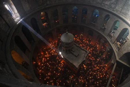 Christian Orthodox pilgrims hold up candles during the Holy Fire ceremony, at the Church of the Holy Sepulcher in the Old City of Jerusalem, Saturday, April 11, 2026. (Credit: Mahmoud Illean/AP.)
