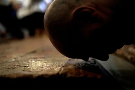 A Christian worshipper kisses the Stone of Unction, the stone slab traditionally claimed as the stone where Jesus' body was prepared for burial, in the Church of the Holy Sepulcher where many Christians believe Jesus was crucified, buried and rose from the dead, in the Old City of Jerusalem, on Good Friday, March 29, 2024. (Credit: Leo Correa/AP.)
