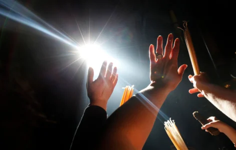 Christian Orthodox pilgrims raise their hands towards a beam of light in front of the Edicule at the Church of the Holy Sepulcher during the ceremony of the Holy Fire in Jerusalem's Old City, Saturday, April 18, 2009. (Credit: Kevin Frayer/AP.)