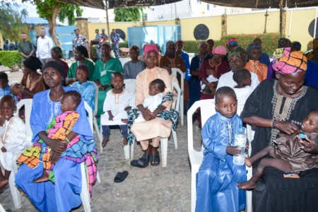 Women and children who were rescued after being held in a forest after they were abducted from the Woro community by gunmen in February sit in a courtyard in Ilorin, Nigeria, on Aug. 7, 2026. (Credit: Abubakar Khadijak/AP.)