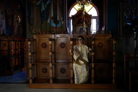 Pantelis, an altar server, sits at the Church of St. Fanourios in Athens, Tuesday, Aug. 25, 2026. (Credit: Thanassis Stavrakis/AP.)