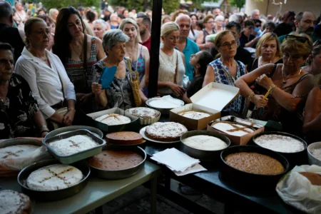Pilgrims wait in line to have their Fanouropites, orange-flavored cakes, blessed at the Church of St. Fanourios in Athens, Wednesday, Aug. 26, 2026. (Credit: Thanassis Stavrakis/AP.)