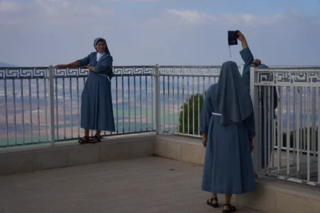 Nuns pose for photograph with the view from the Basilica of the Transfiguration on Mount Tabor, northern Israel, Aug. 6, 2026. (Credit: Ariel Schalit/AP.)