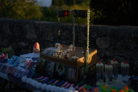 Religious souvenirs for sale are placed on a stand for Christian pilgrims who climb to the Basilica of the Transfiguration on Mount Tabor, northern Israel, on Aug. 6, 2026. (Credit: Ariel Schalit/AP.)