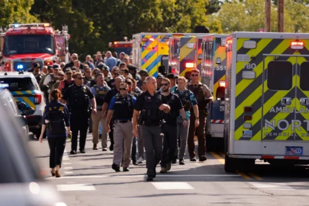 Law enforcement officers gather outside the Annunciation Church's school in response to a reported mass shooting, Aug. 27, 2025, in Minneapolis. (Credit: Bruce Kluckhohn/AP.)