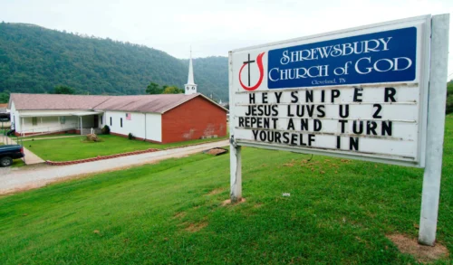 A sign in front of the Shrewsbury Church of God in Shrewsbury, W.Va., shown, Aug. 22, 2003, includes a message concerning three fatal shootings in the Charleston, W.Va.-area. (Credit: Bob Bird/AP.)