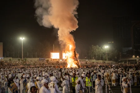 People chant as the bonfire lights during celebrations for the Orthodox holiday of Meskel, an annual holiday celebrating the discovery of the True Cross in the fourth century by the Roman Empress Helena, in Addis Ababa, Ethiopia, Saturday, Sept. 26, 2026. (Credit: Amanuel Sileshi/AP.)