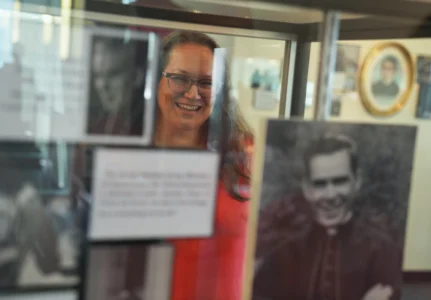 Bonnie Engstrom, who believes the late Archbishop Fulton Sheen helped save her son's life after he was born in 2010 without a pulse, looks at a photo of Sheen on display at the Sheen Museum in Peoria, Ill., on July 16, 2026. (Credit: Jessie Wardarski/AP.)